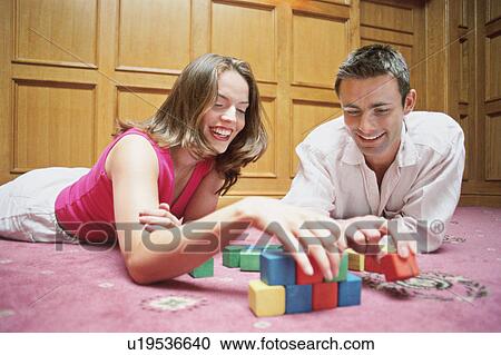 Stock Image - Couple playing with wooden blocks. Fotosearch