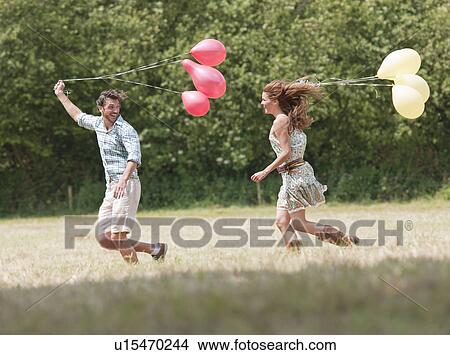 couple running with balloons View Large Photo Image Picture - couple running with balloons. Fotosearch
