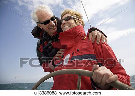 Stock Photo - Couple sailing yacht. Fotosearch