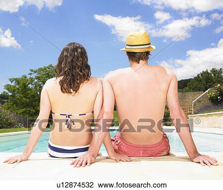 couple sitting by pool View Large Photo Image Stock Image - couple sitting by pool. Fotosearch