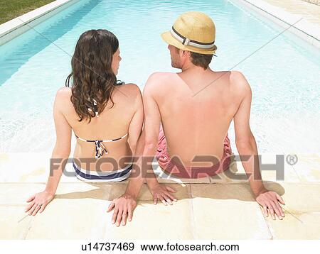 couple sitting by pool View Large Photo Image Stock Photo - couple sitting by pool. Fotosearch