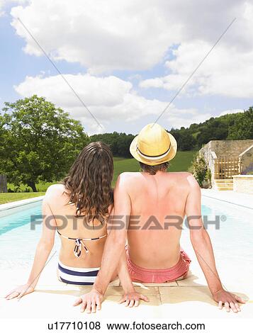 couple sitting by pool View Large Photo Image Stock Photo - couple sitting by pool. Fotosearch