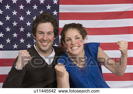 Couple smiling with American flag View Large Photo Image Stock Image - Couple smiling with American flag. Fotosearch