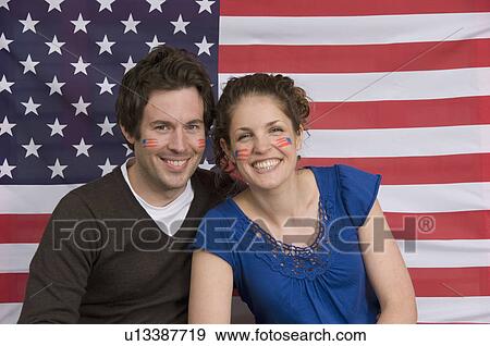 Couple smiling with American flag View Large Photo Image Stock Photo - Couple smiling with American flag. Fotosearch