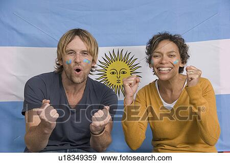 Stock Photo - Couple smiling with Argentinian flag. Fotosearch