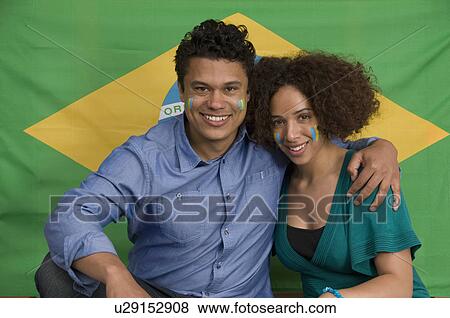 Couple smiling with Brazilian flag View Large Photo Image Stock Photo - Couple smiling with Brazilian flag. Fotosearch