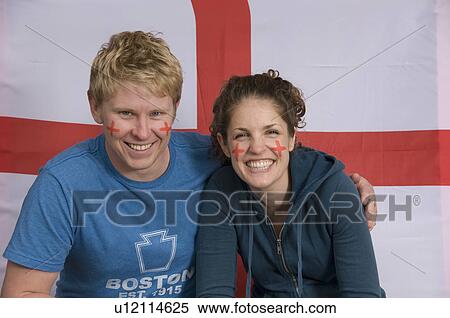 Stock Photography - Couple smiling with English flag. Fotosearch
