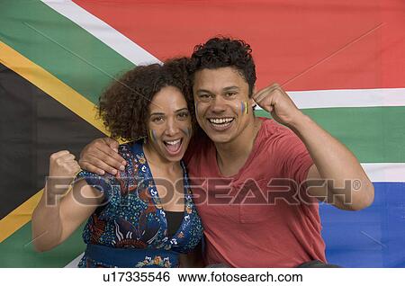 Couple smiling with South African flag View Large Photo Image Stock Photograph - Couple smiling with South African flag. Fotosearch