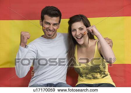 Stock Photo - Couple smiling with Spanish flag. Fotosearch