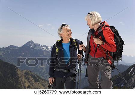 Stock Photo - couple talking on ski tour in mountains. Fotosearch