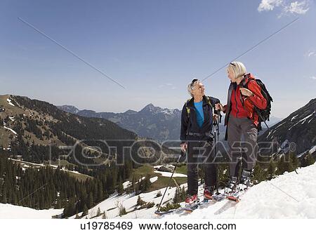Stock Photo - couple talking on ski tour in mountains. Fotosearch