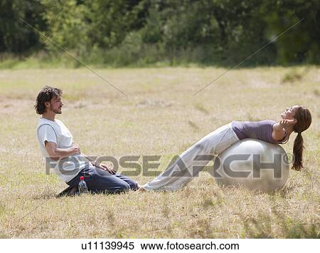 couple with yoga ball stretching View Large Photo Image Stock Photography - couple with yoga ball stretching. Fotosearch