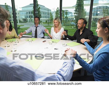 Coworkers holding hands View Large Photo Image Stock Image - Coworkers holding hands. Fotosearch
