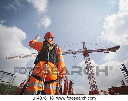 Stock Photograph - Crane Worker Directing Cranes. Fotosearch