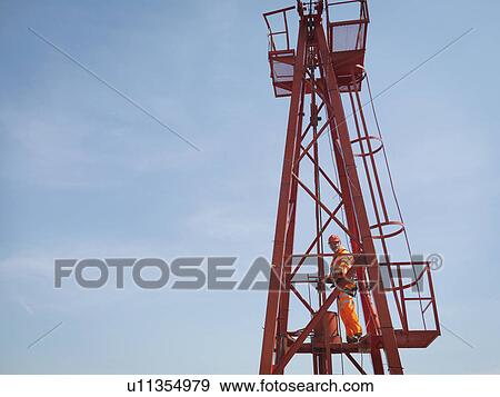 Stock Photo - Crane Worker High Up On Crane. Fotosearch