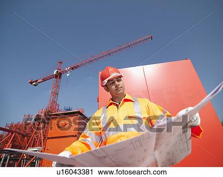 Crane Worker Holding Plans View Large Photo Image Stock Image - Crane Worker Holding Plans. Fotosearch