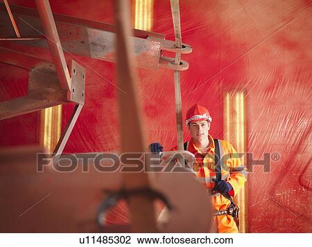 Stock Image - Crane Worker In Harness. Fotosearch
