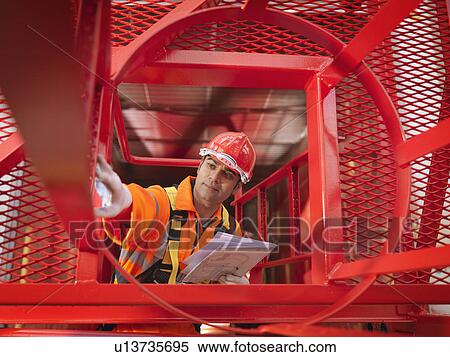 Crane Worker Inspecting Crane View Large Photo Image Stock Photography - Crane Worker Inspecting Crane. Fotosearch