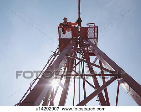 Crane Worker Looking Down From Crane View Large Photo Image Stock Photo - Crane Worker Looking Down From Crane. Fotosearch