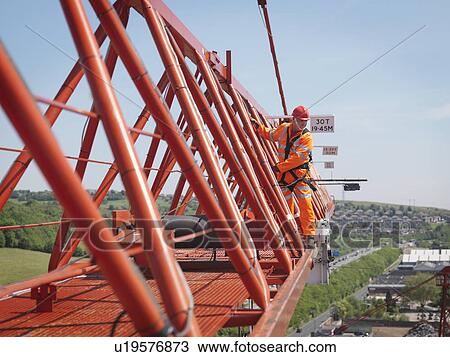 Crane Worker On Arm Of Crane View Large Photo Image Stock Image - Crane Worker On Arm Of Crane. Fotosearch