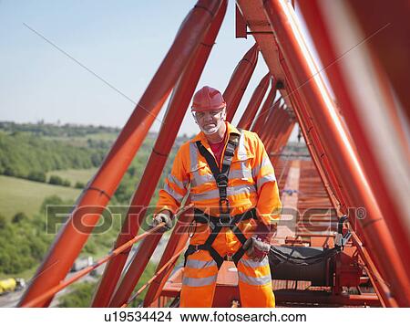Picture - Crane Worker With Harness On Crane. Fotosearch