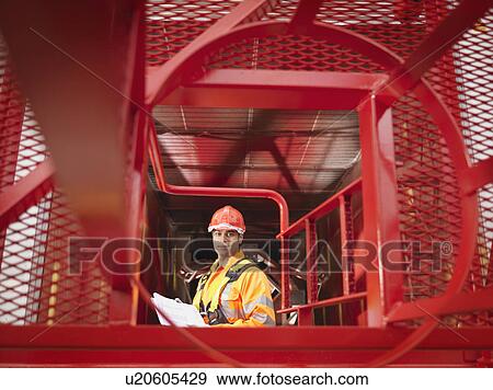 Stock Photo - Crane Worker With Notes. Fotosearch