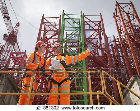Crane Workers Discussing Cranes View Large Photo Image Stock Image - Crane Workers Discussing Cranes. Fotosearch