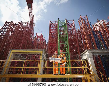 Crane Workers With Plans View Large Photo Image Stock Image - Crane Workers With Plans. Fotosearch