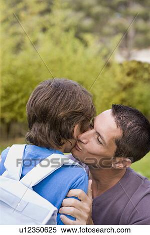dad kissing boy going to school View Large Photo Image Stock Photography - dad kissing boy going to school. Fotosearch