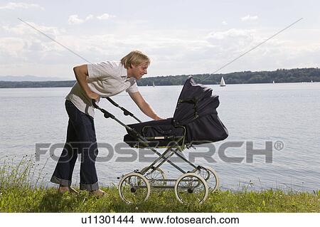dad pushing baby in pram View Large Photo Image Picture - dad pushing baby in pram. Fotosearch