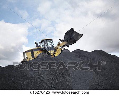 Stock Photography - Digger On Pile Of Coal In Mine. Fotosearch