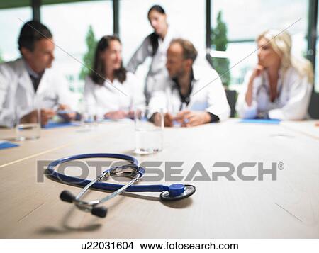 Picture - Doctors around a table. Fotosearch