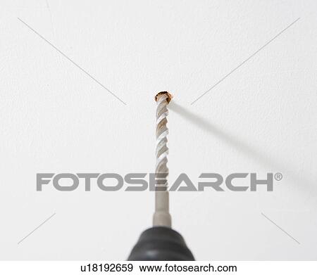 Stock Photo - drill making hole in wall. Fotosearch