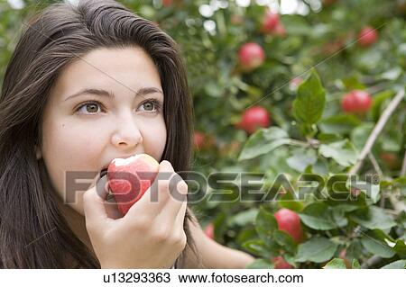 Stock Image - Eating red apple 01. Fotosearch