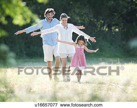 Stock Photo - Family fun walking in country field. Fotosearch