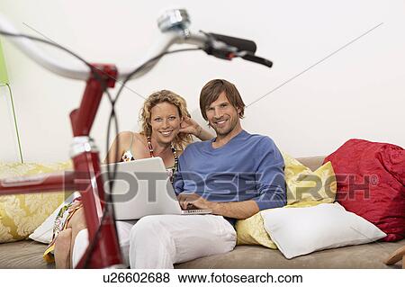 Stock Photo - family homeshopping. Fotosearch