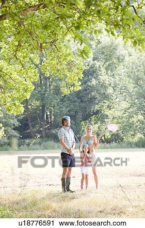 Family in countryside playing with nets View Large Photo Image Stock Image - Family in countryside playing with nets. Fotosearch