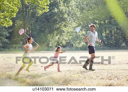 Family in countryside running with nets View Large Photo Image Stock Image - Family in countryside running with nets. Fotosearch