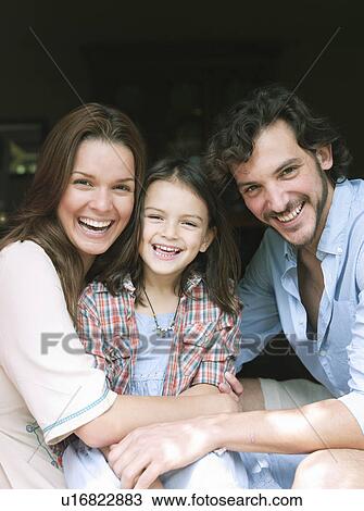 Family laughing together in house View Large Photo Image Stock Image - Family laughing together in house. Fotosearch