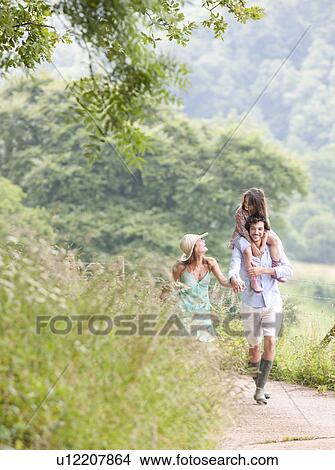 Family laughing together on lane View Large Photo Image Picture - Family laughing together on lane. Fotosearch