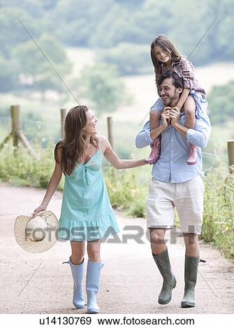 Family laughing together on lane View Large Photo Image Stock Photo - Family laughing together on lane. Fotosearch