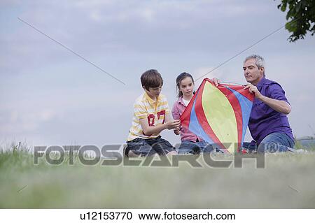 family of three building kite View Large Photo Image Stock Image - family of three building kite. Fotosearch