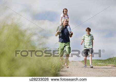 family of three walking down the road View Large Photo Image Stock Photograph - family of three walking down the road. Fotosearch