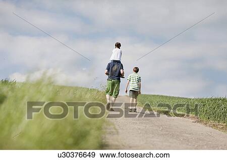 family of three walking up the road View Large Photo Image Stock Photo - family of three walking up the road. Fotosearch