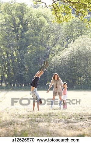 Family playing in country field View Large Photo Image Stock Image - Family playing in country field. Fotosearch