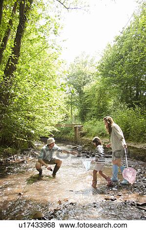 Family playing in country stream View Large Photo Image Stock Photo - Family playing in country stream. Fotosearch