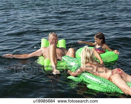 Picture - Family playing in water. Fotosearch