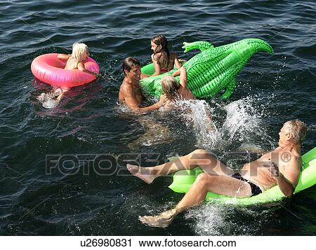 Stock Image - Family playing in water. Fotosearch