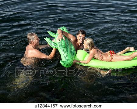 Stock Photo - Family playing in water. Fotosearch