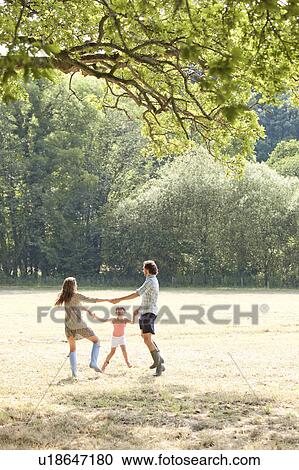 Family playing together in country field View Large Photo Image Stock Image - Family playing together in country field. Fotosearch